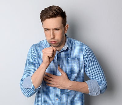 Young man coughing